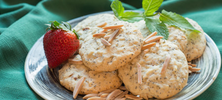 Almond Poppyseed Cookies on plate with strawberry and mint