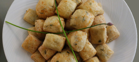 Italian Cheese Biscuits on white plate with chive garnish