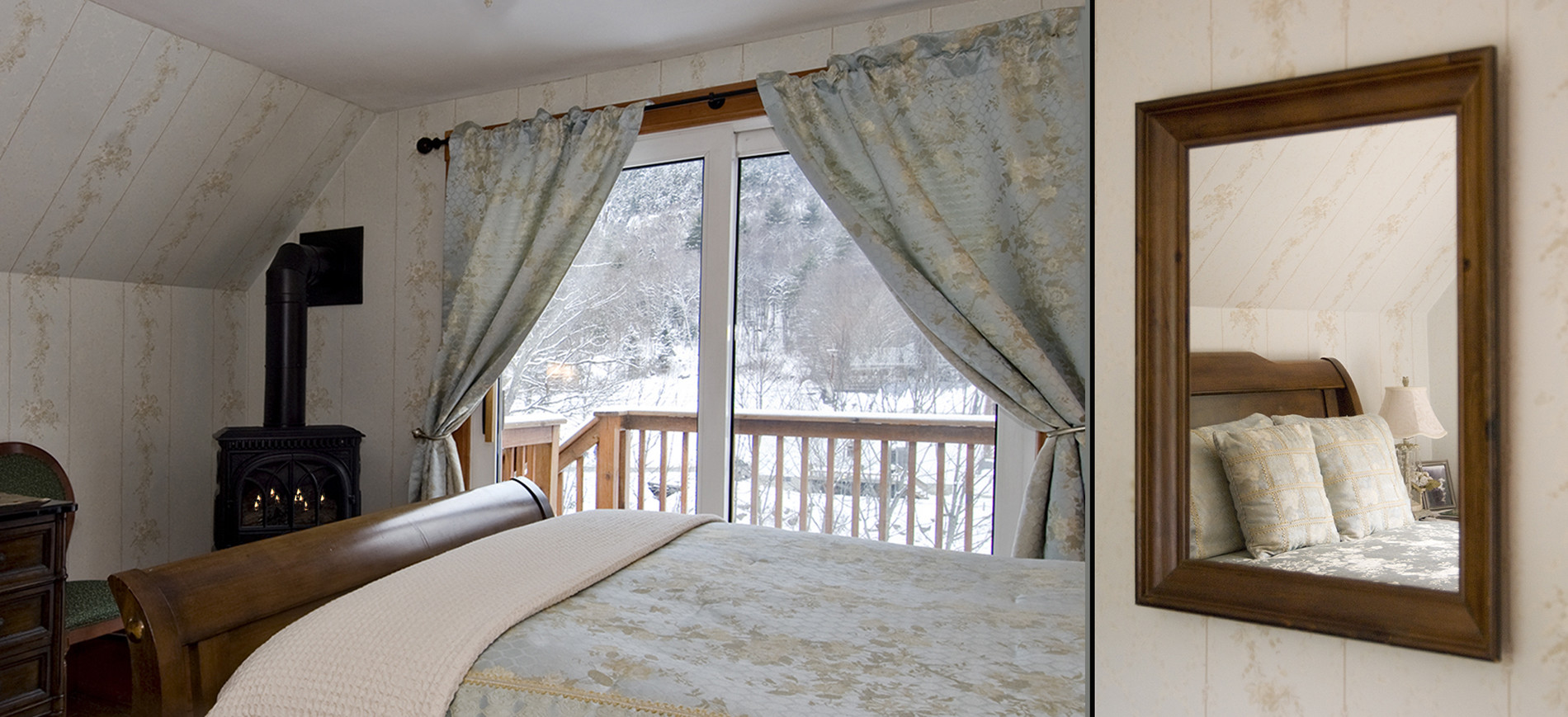 Guest room with chest & TV, chair, gas woodstove, sliding glass doors onto snowy balcony, queen bed with silver blue bedding reflected in mirror