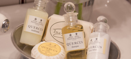 bottles of Quercus bath produces & round soap in silver dish