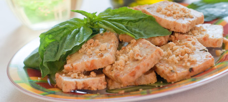 Pignoli Bite cookies on plate with basil garnish