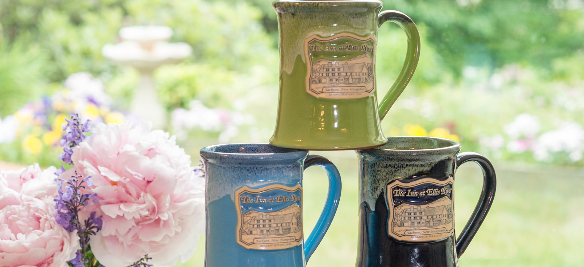 Peonies to left of three coffee mugs