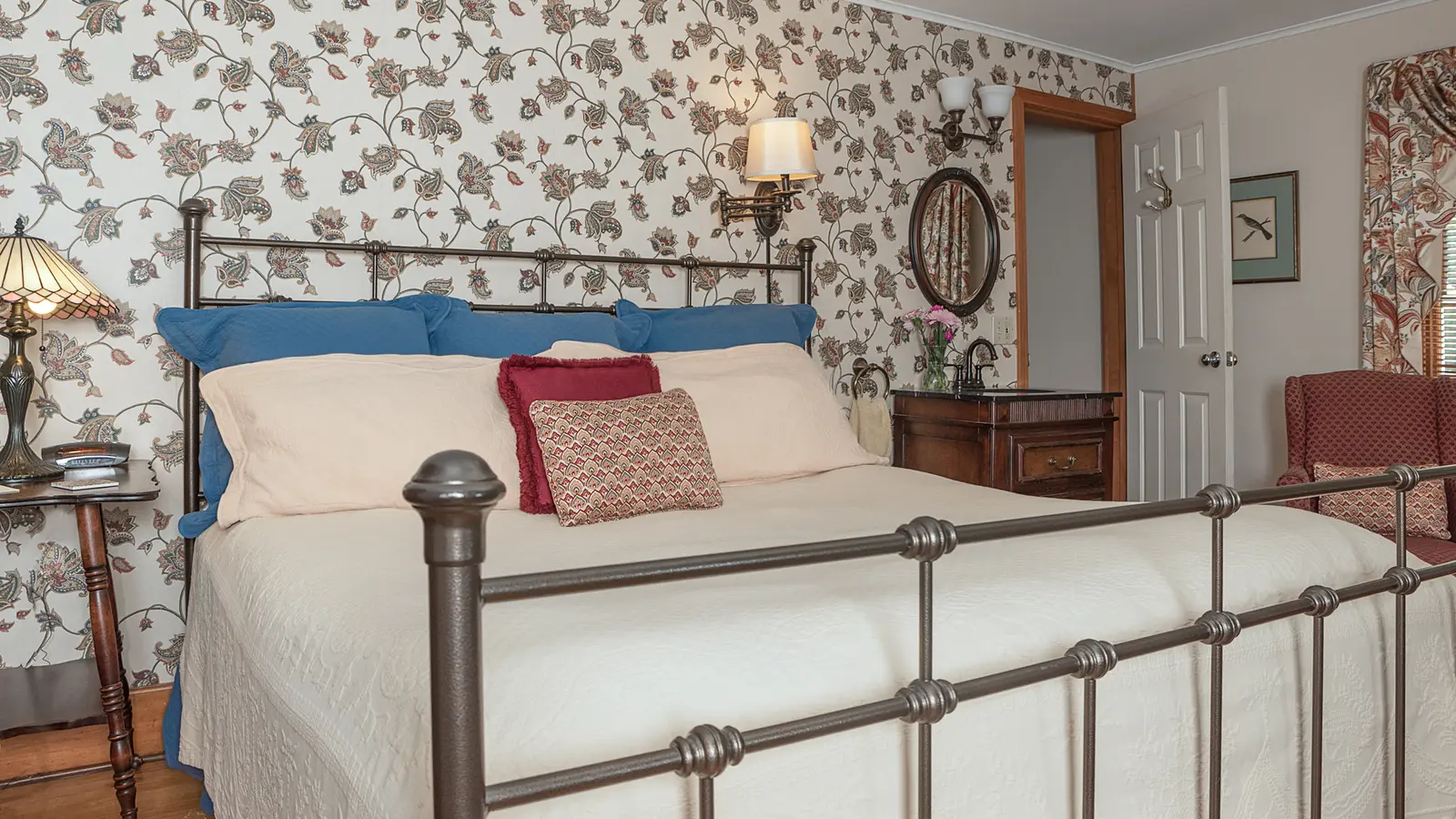 Dianas Baths - bed with view of sink and bathroom door.