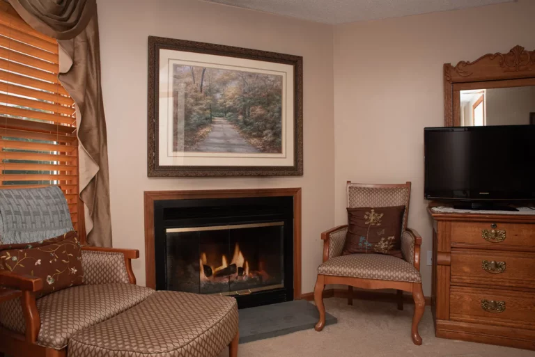 Living room with a fireplace and framed art.