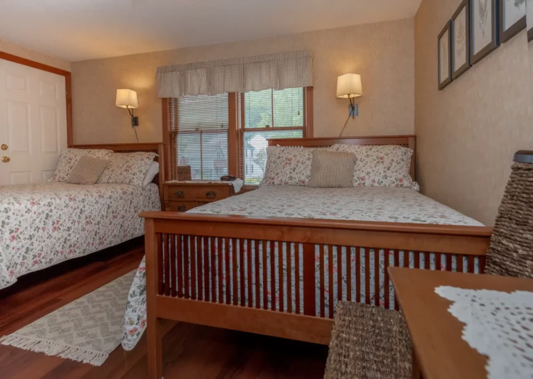 twin beds with wooden frames and floral comforters.