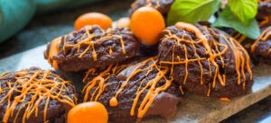 Spirited chocolate cookies with orange drizzle, kumquats & mint garnish.