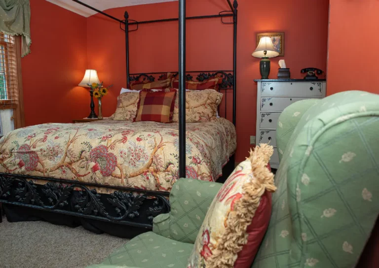 Bedroom with a four-poster bed and lamp.