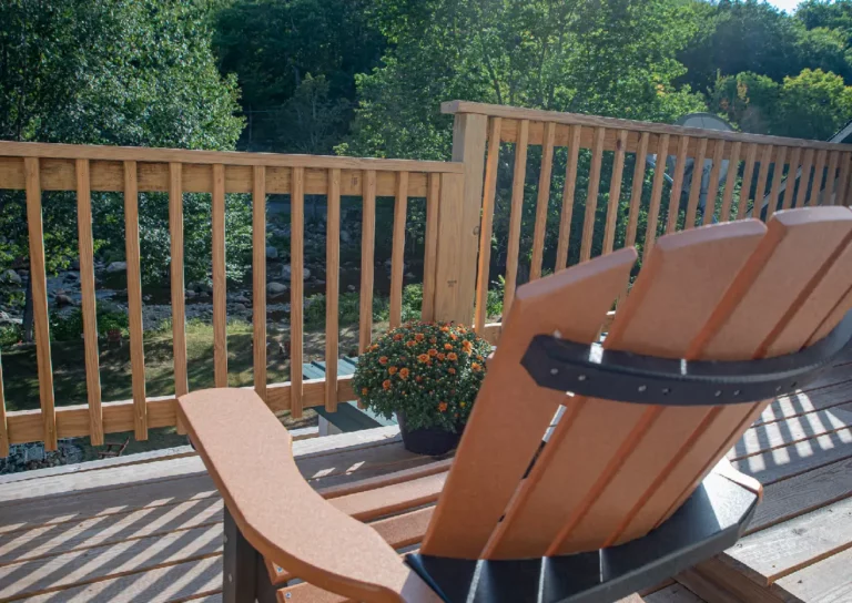 Balcony with wooden chair and nature view.