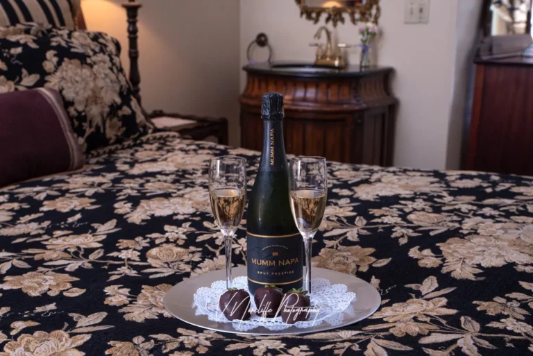 Wine bottle, glasses, and candlelit ambiance.